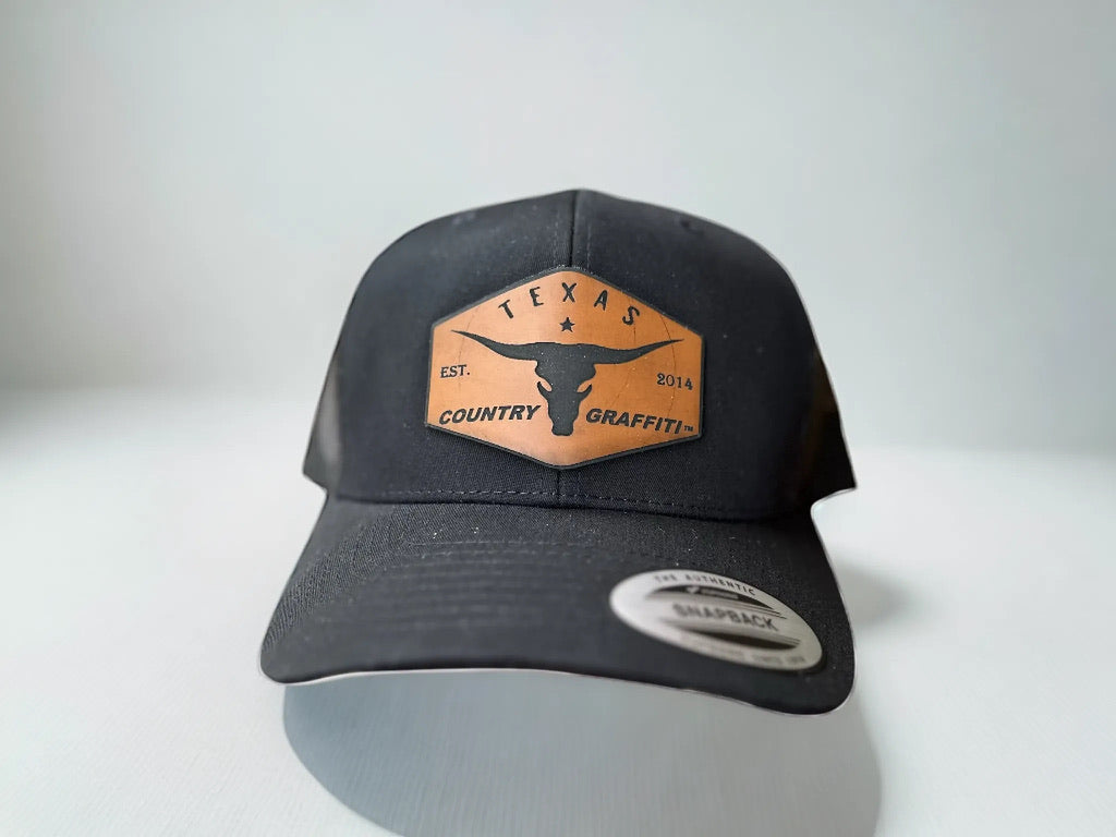 black yupoong trucker cap with a texas country graffiti and a long horn