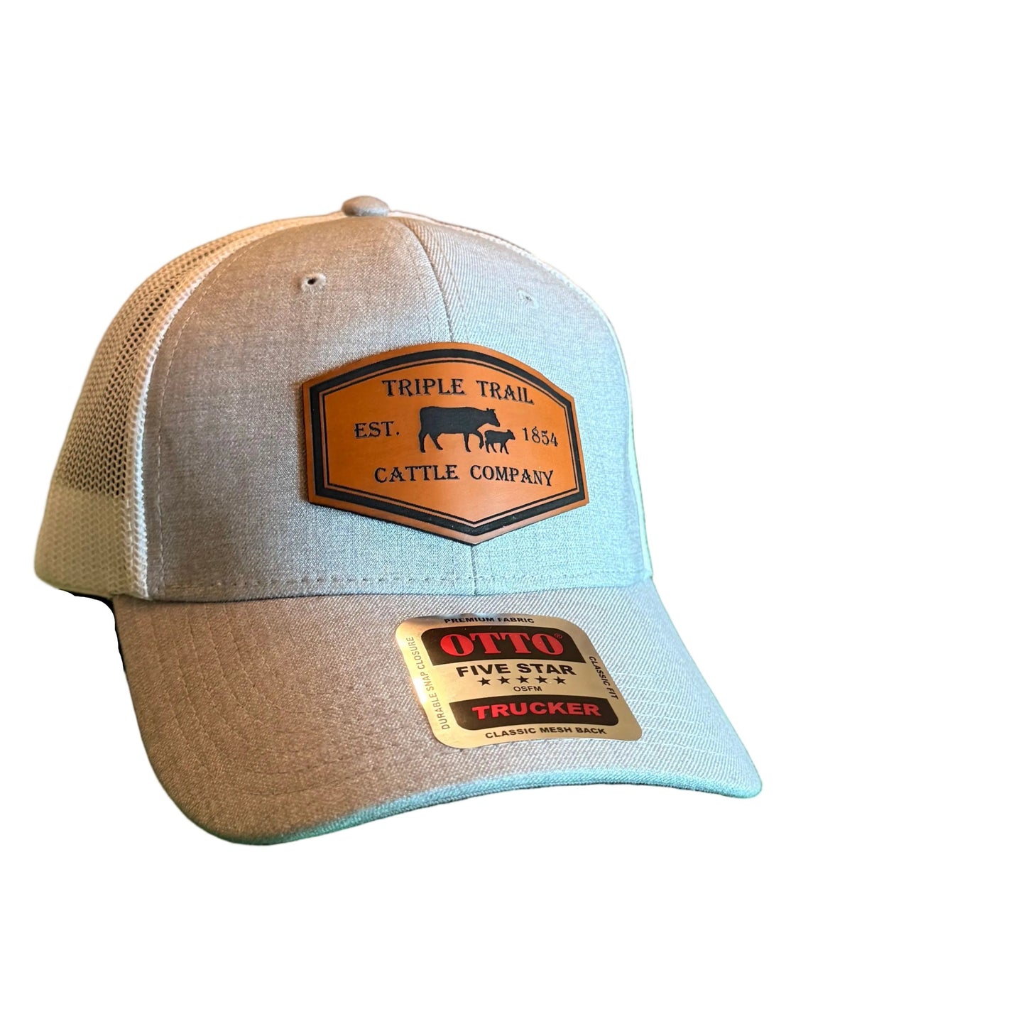 A light gray heather trucker-style baseball cap with two gold-toned patches, 
