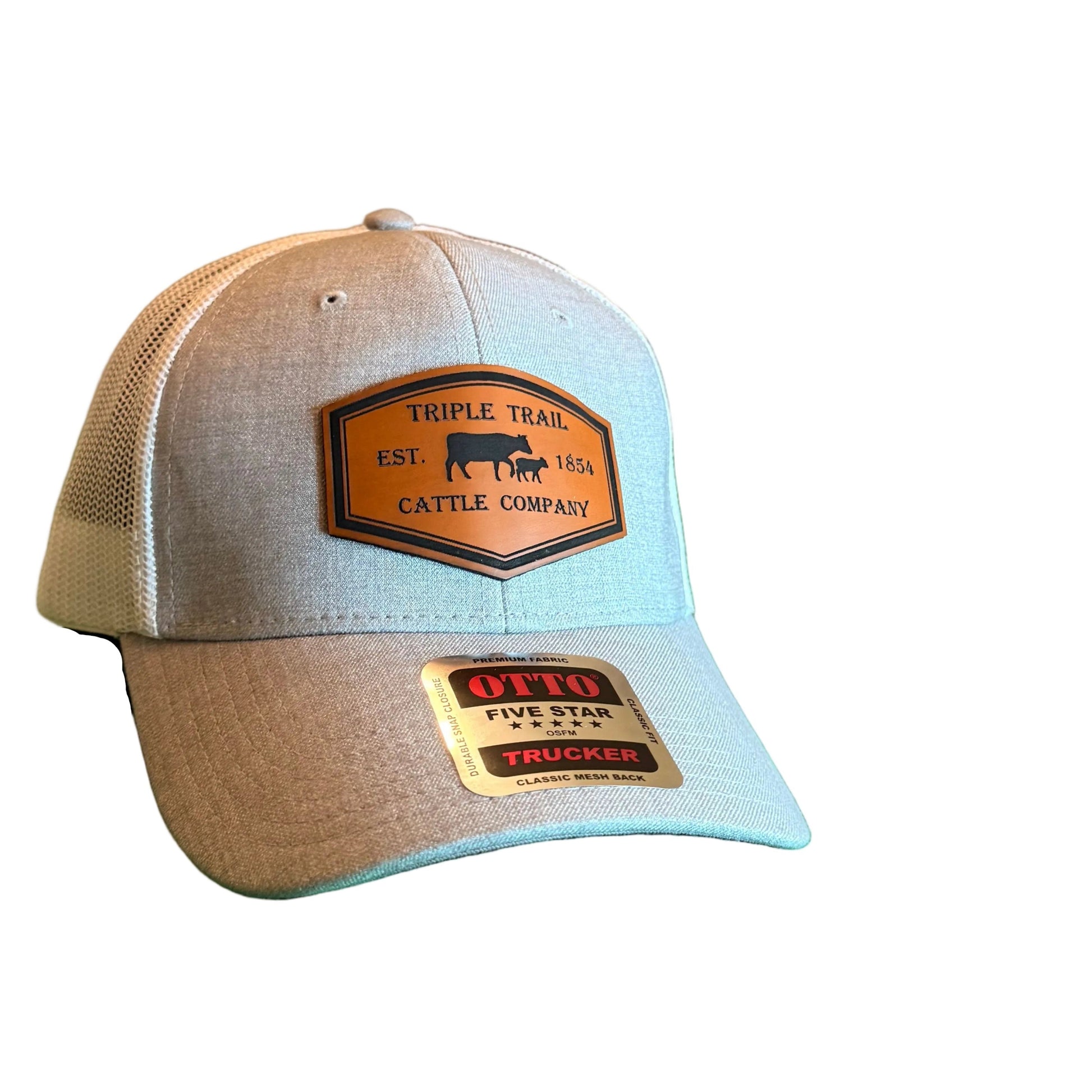 A light gray heather trucker-style baseball cap with two gold-toned patches, 