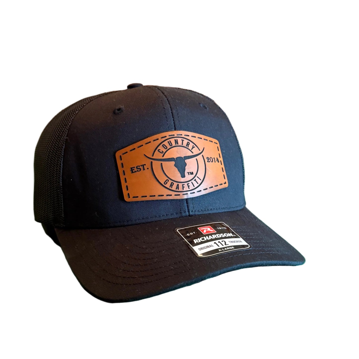 A dark navy baseball cap with a tan leather patch logo.