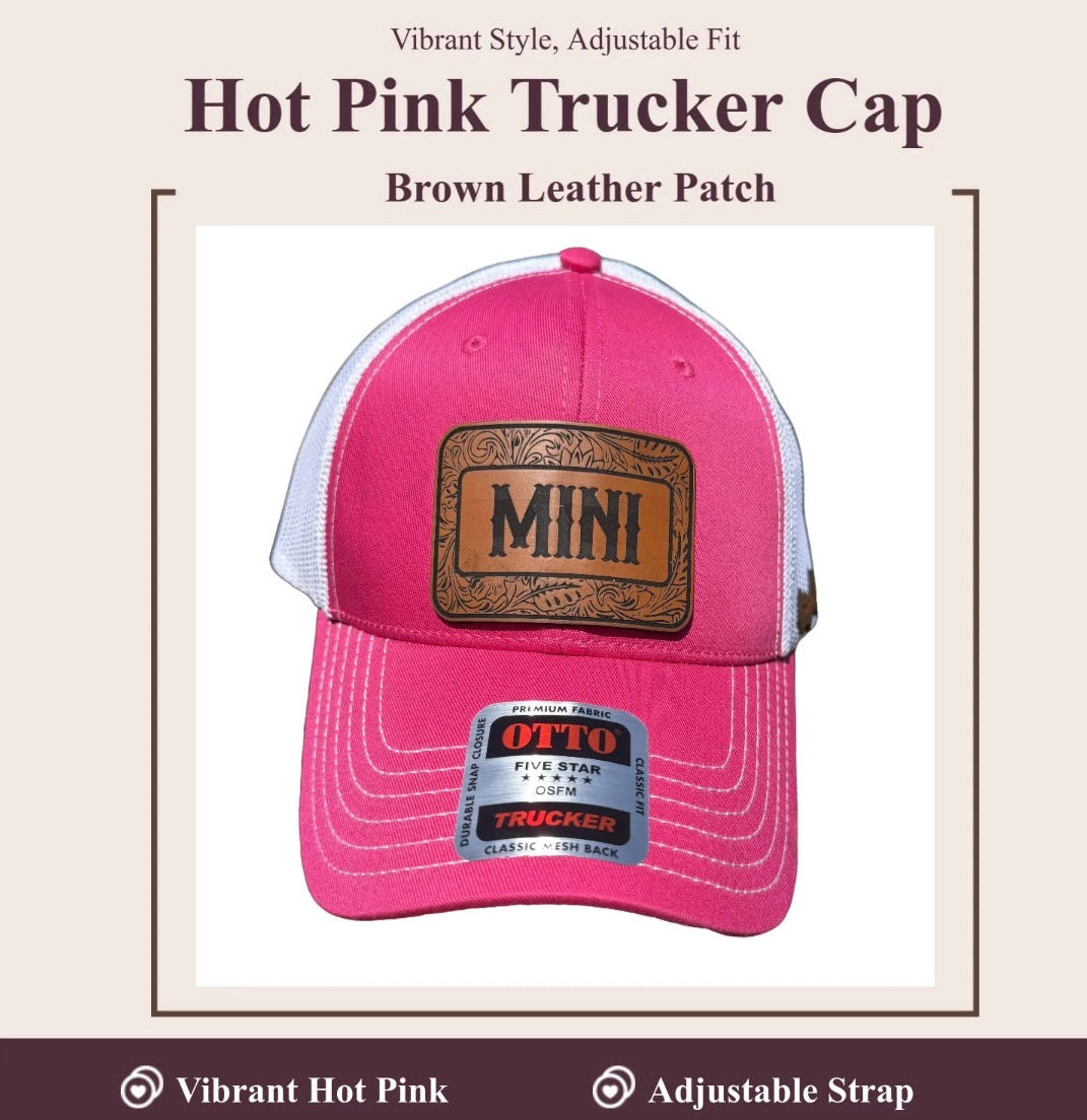 A hot pink trucker cap with brown leather patch detailing, shown on a light beige background with promotional text. The cap features a bright pink front panel and brim, white mesh back, and a brown patch on the front with 'MINI' written on it.